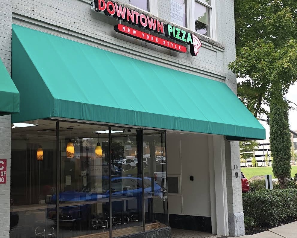 Downtown Pizza storefront at 156 Magnolia Street in Spartanburg, SC — historic-building facade with teal awning and large front windows.